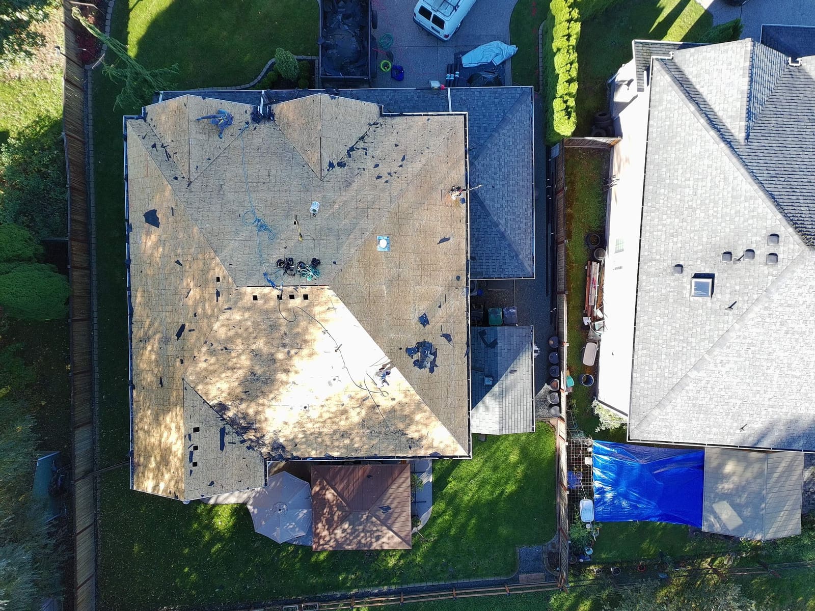 Aerial view of the roof before replacement, showing worn shingles